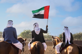 A group of people riding on the backs of horses