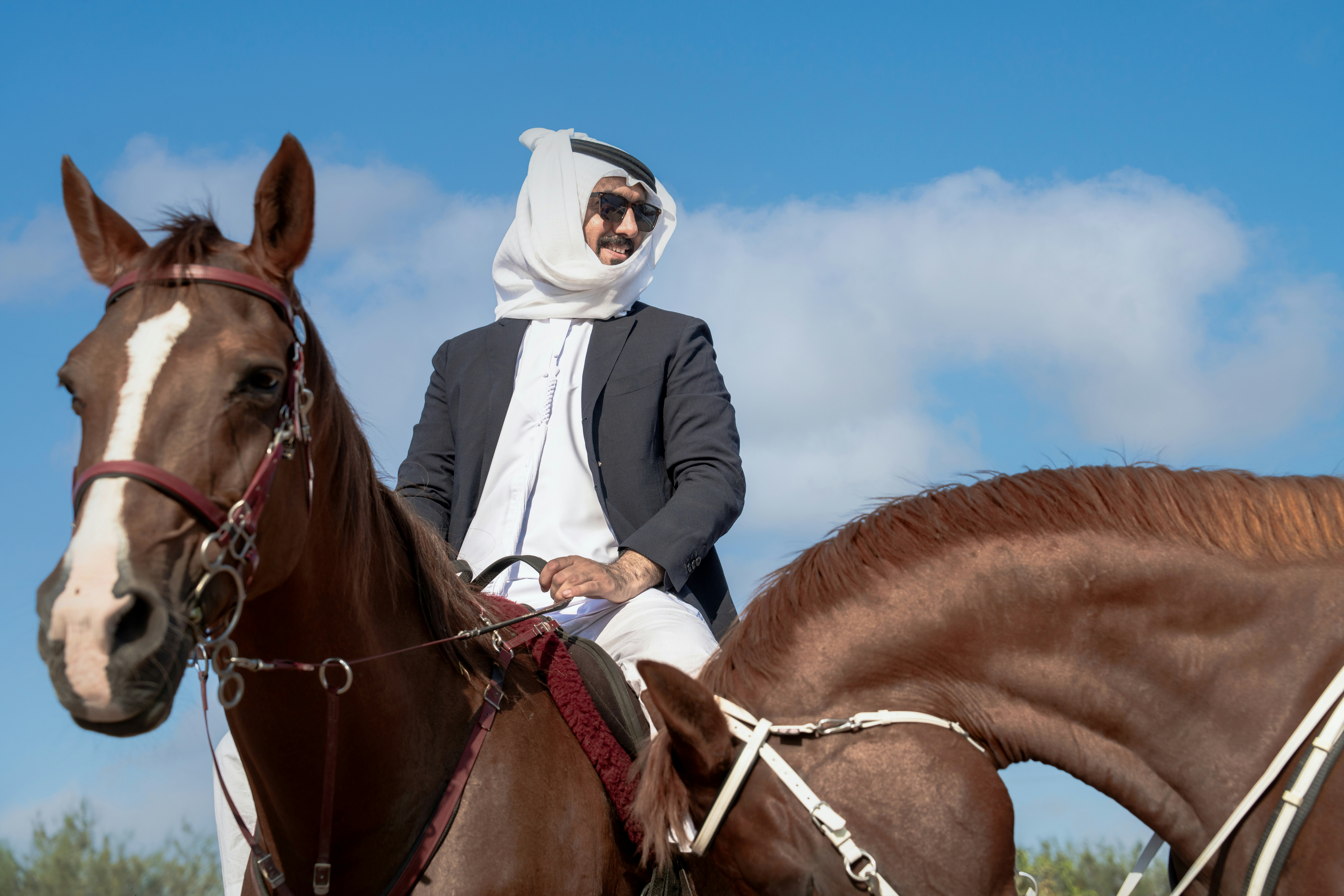 A man riding on the back of a brown horse