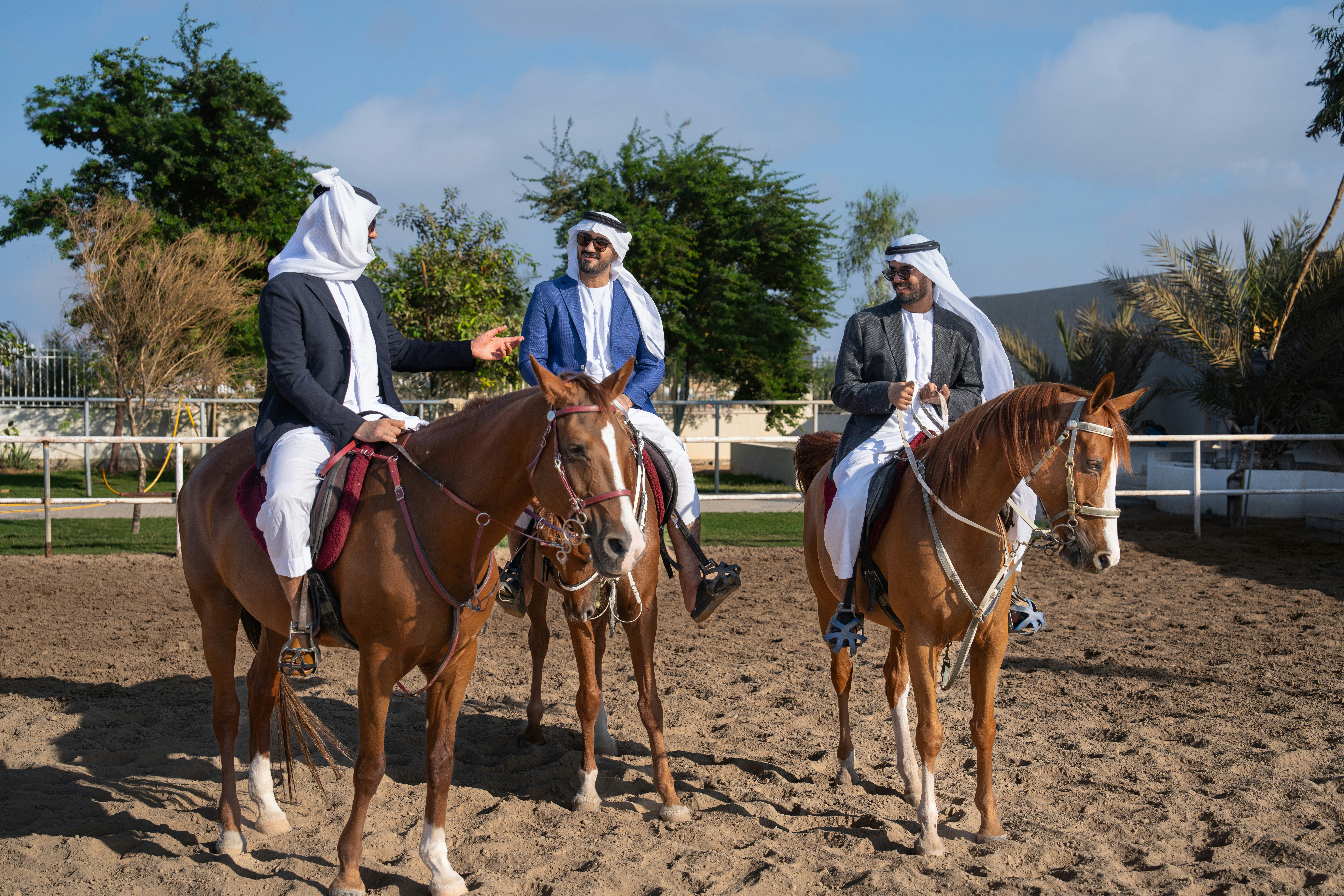 A group of men riding on the backs of brown horses