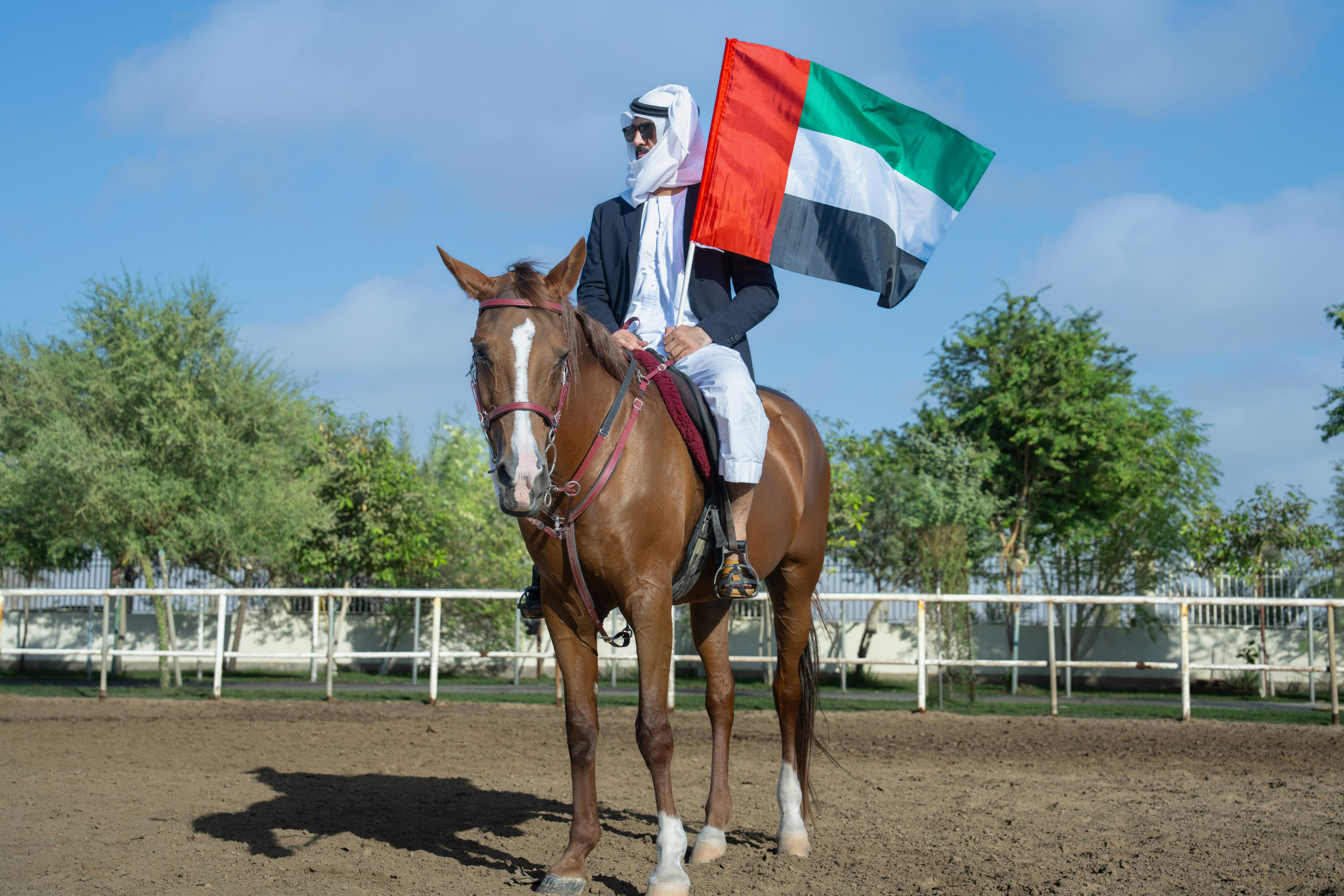 A man riding on the back of a brown horse