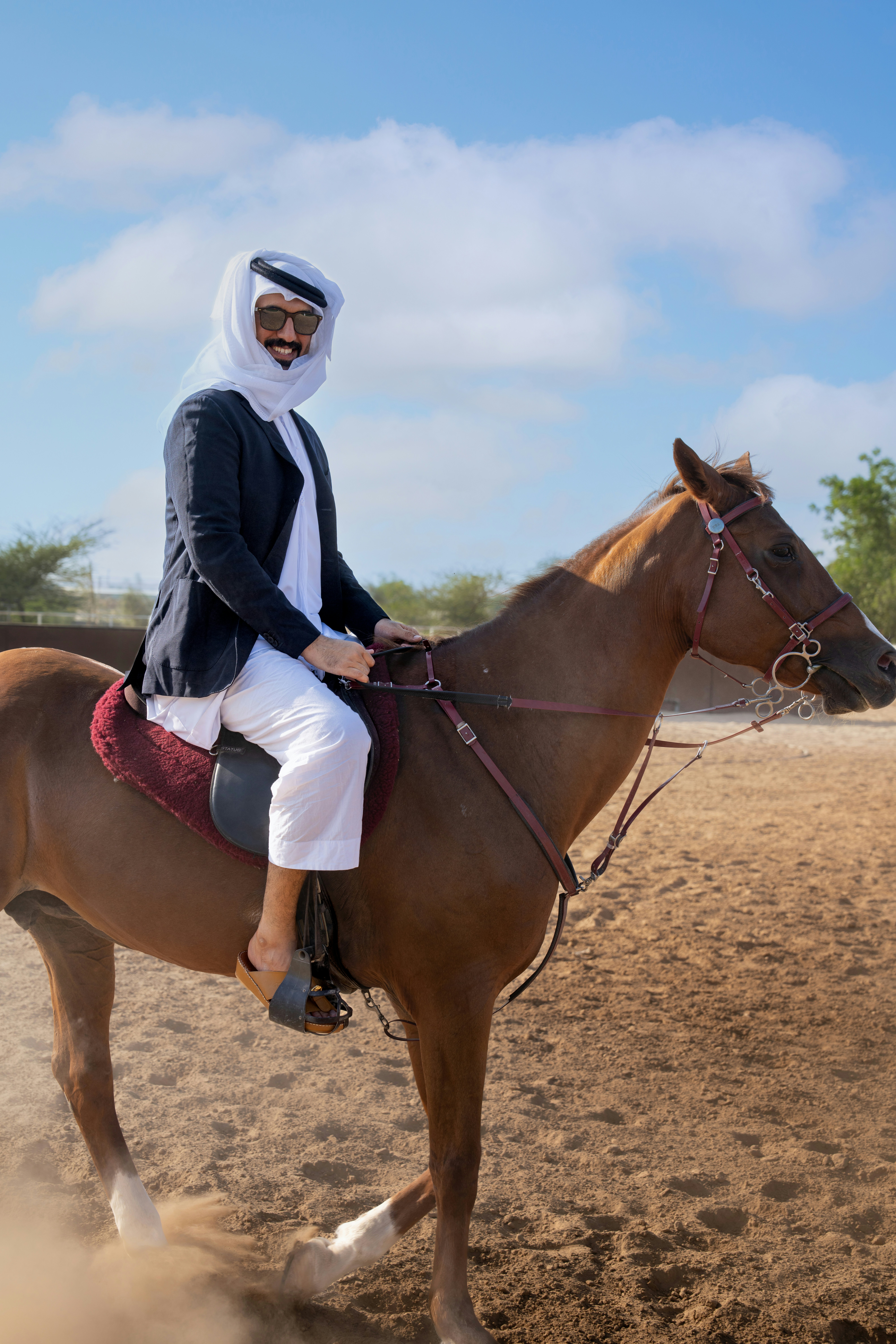 A person riding a horse on a dirt field