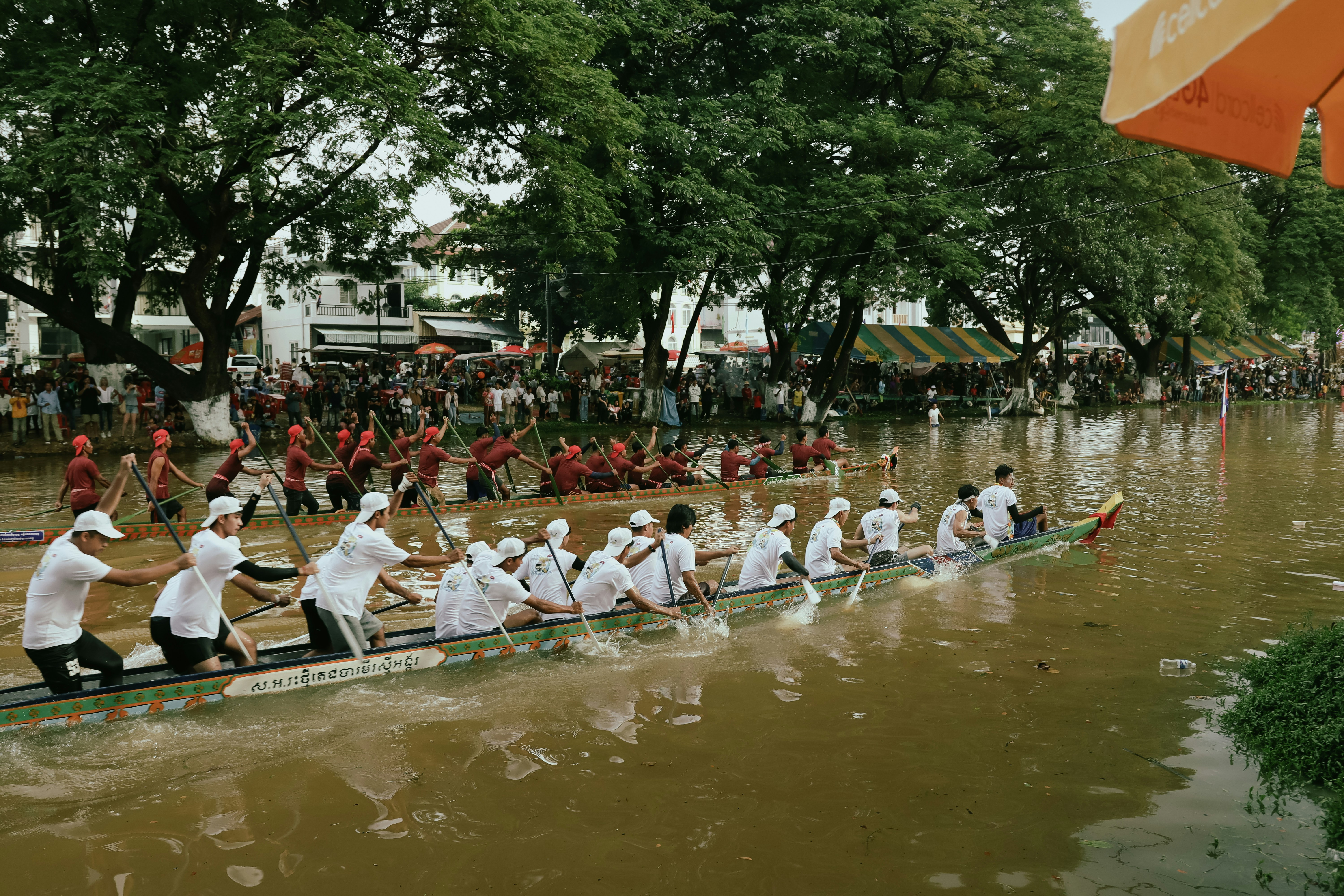 A group of people on a long boat in the water