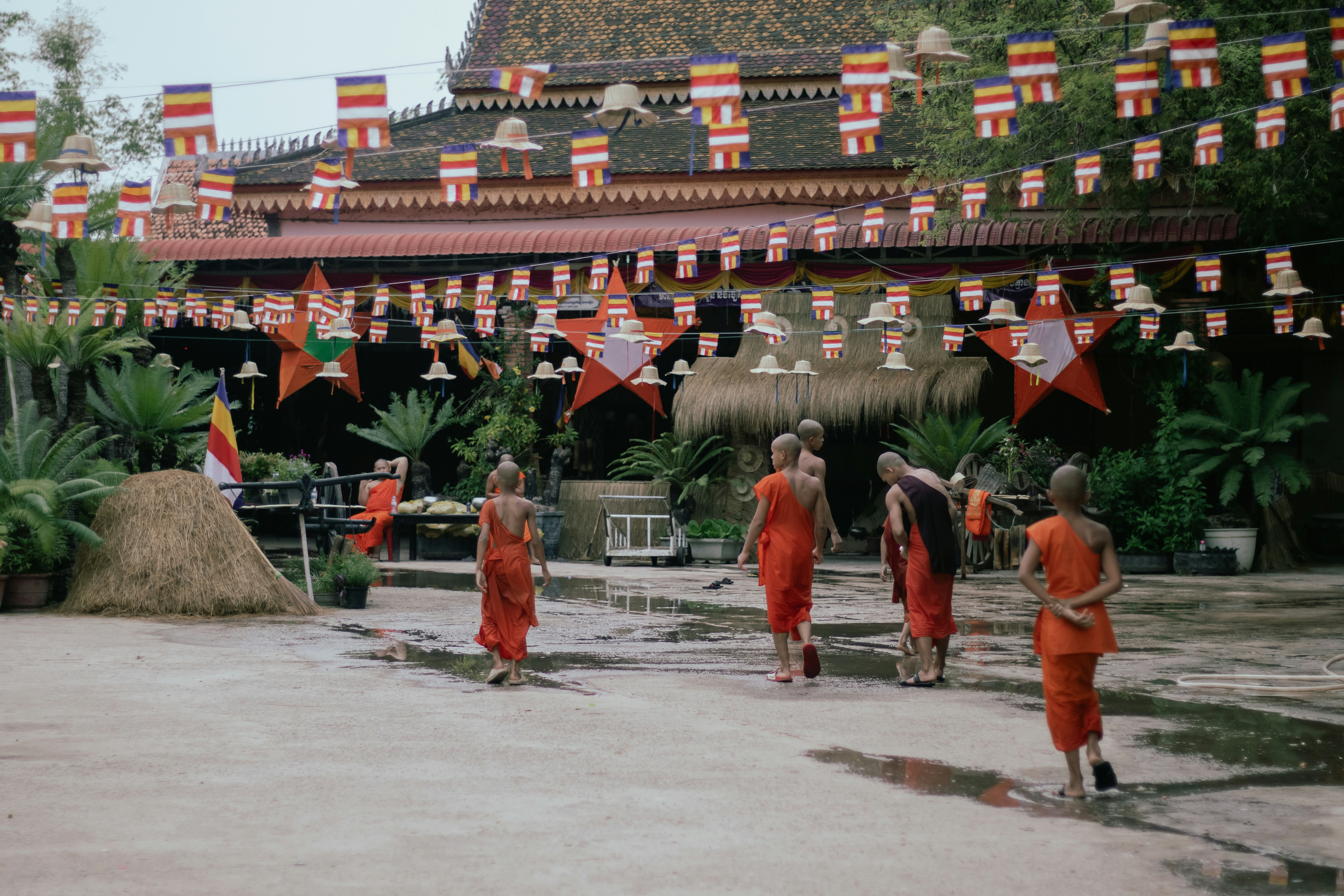 A group of people in orange outfits walking down a street