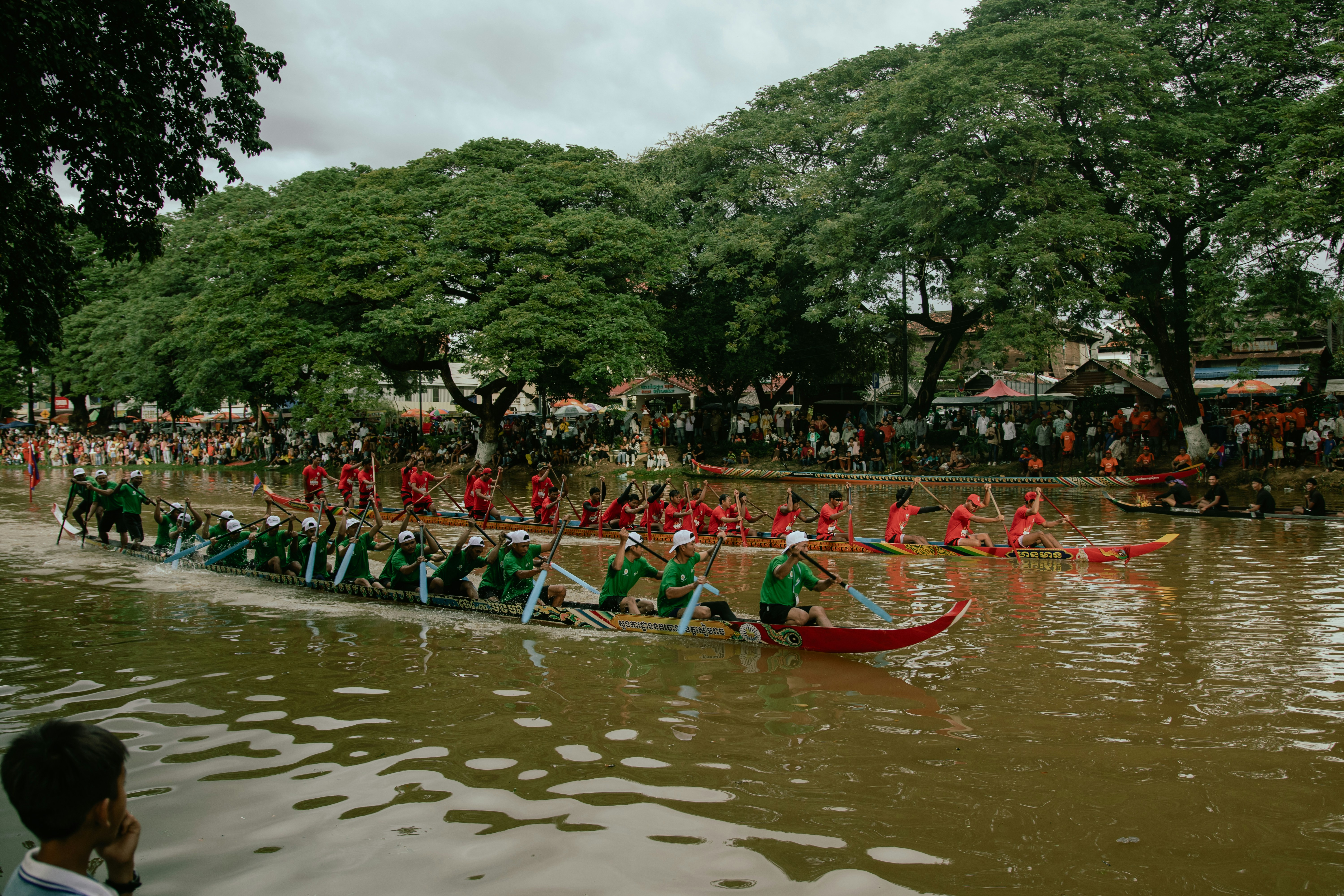 A group of people riding on top of a long boat