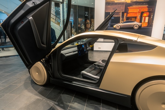 A car with its door open on display in a museum