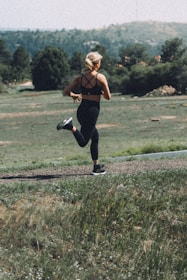 A woman running on a trail in a field