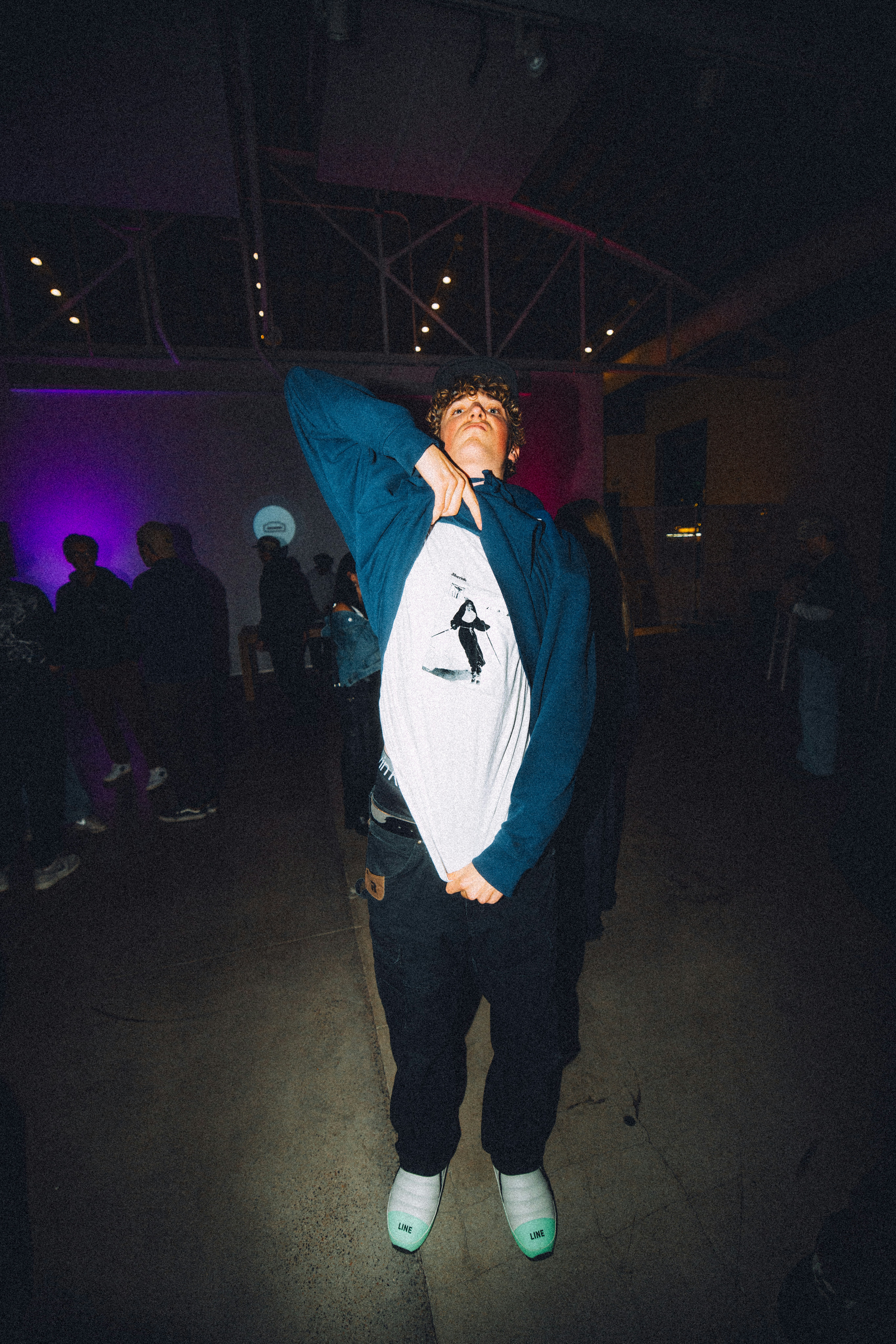 A man standing in a dark room with his arms in the air photo – Free ...