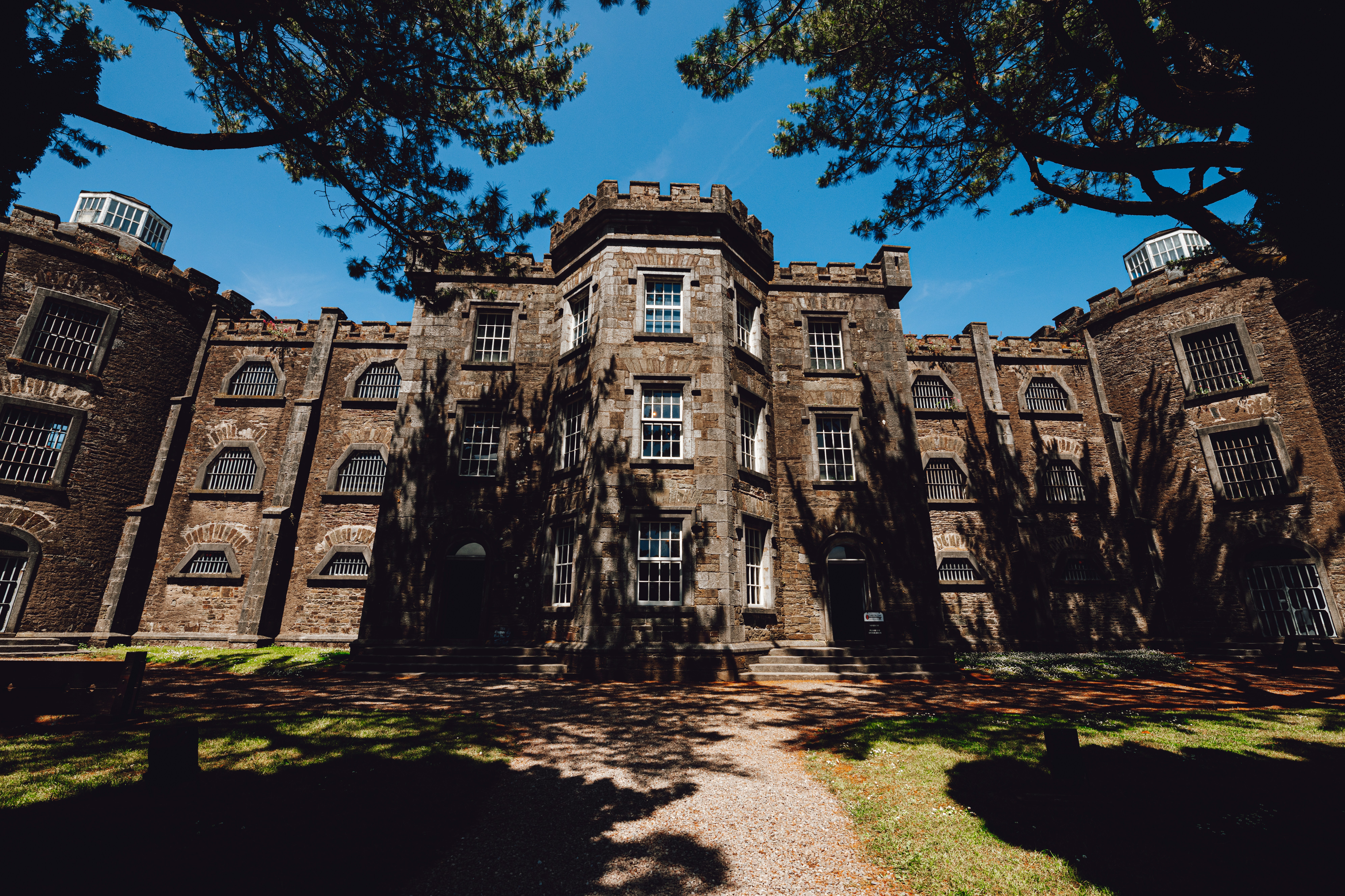 A large building with many windows and trees in front of it
