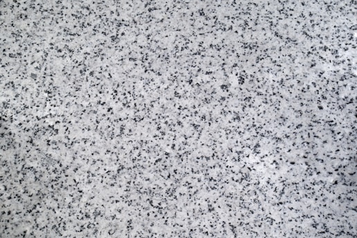 A black and white photo of a granite counter top