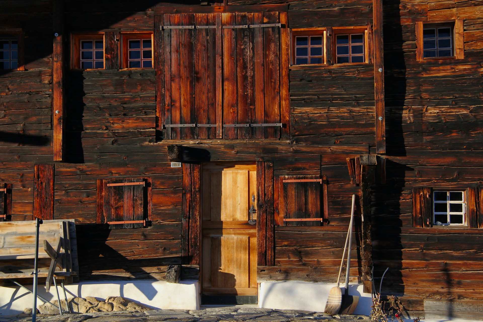 A large wooden building with windows and doors