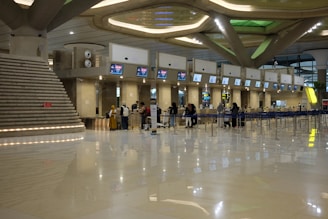 A group of people standing around in an airport