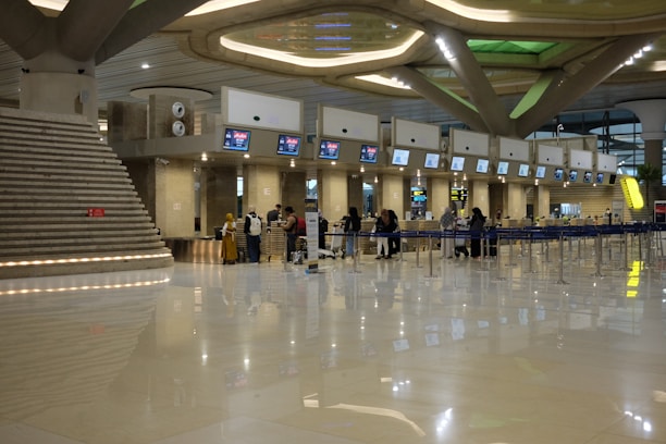 A group of people standing around in an airport