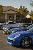 A row of cars parked in front of a building