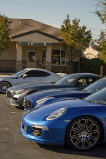 A row of cars parked in front of a building