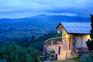 A small cabin on a hill overlooking a valley