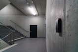 An empty room with stairs and a door
