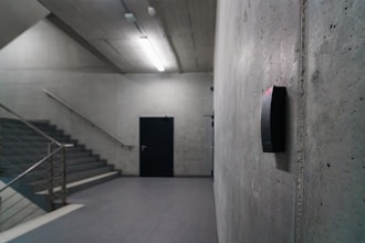 An empty room with stairs and a door