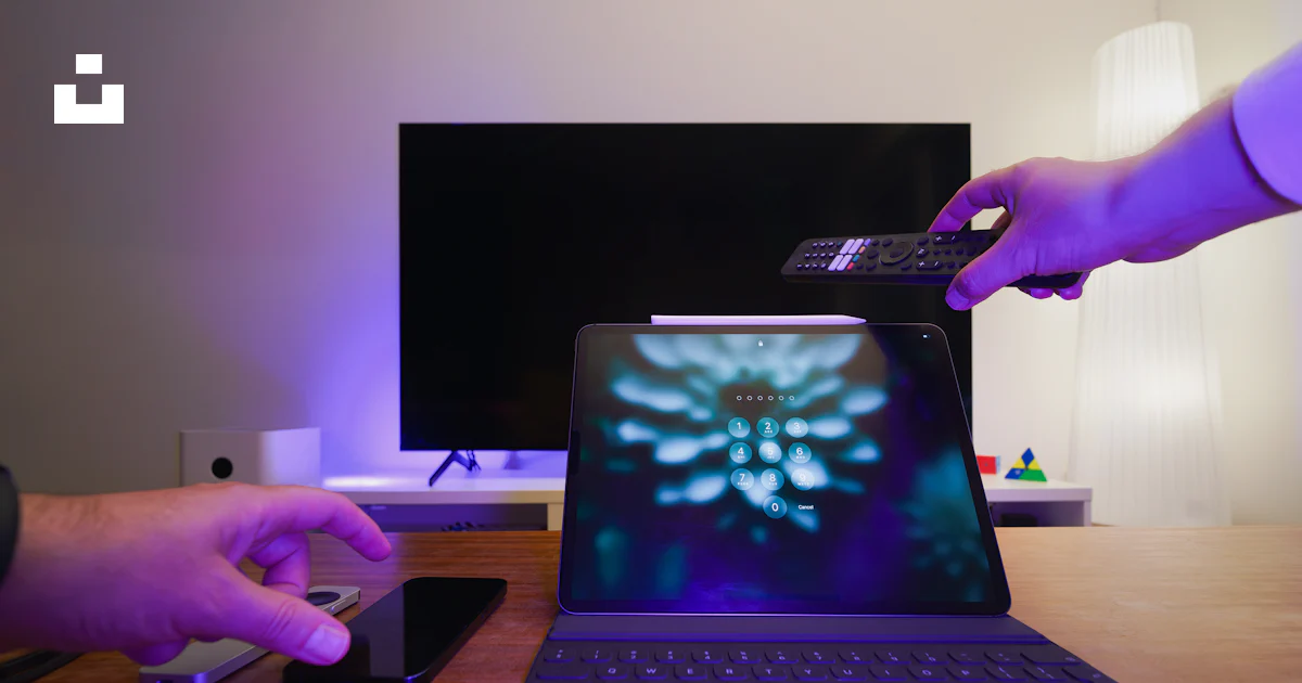 Computer Remote Control Oics A person is holding a remote control over a laptop photo – Free ...