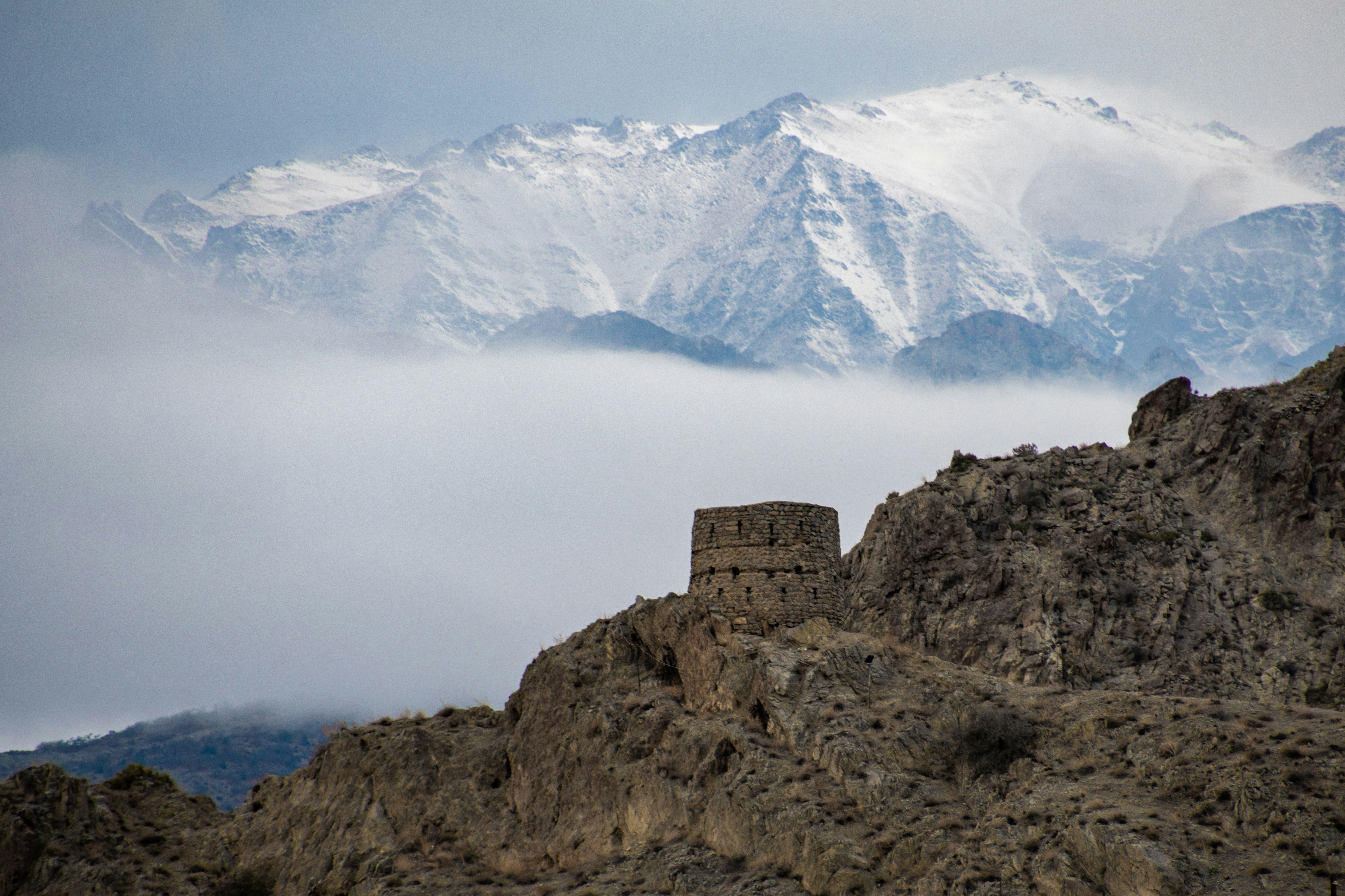 A mountain with a castle on top of it