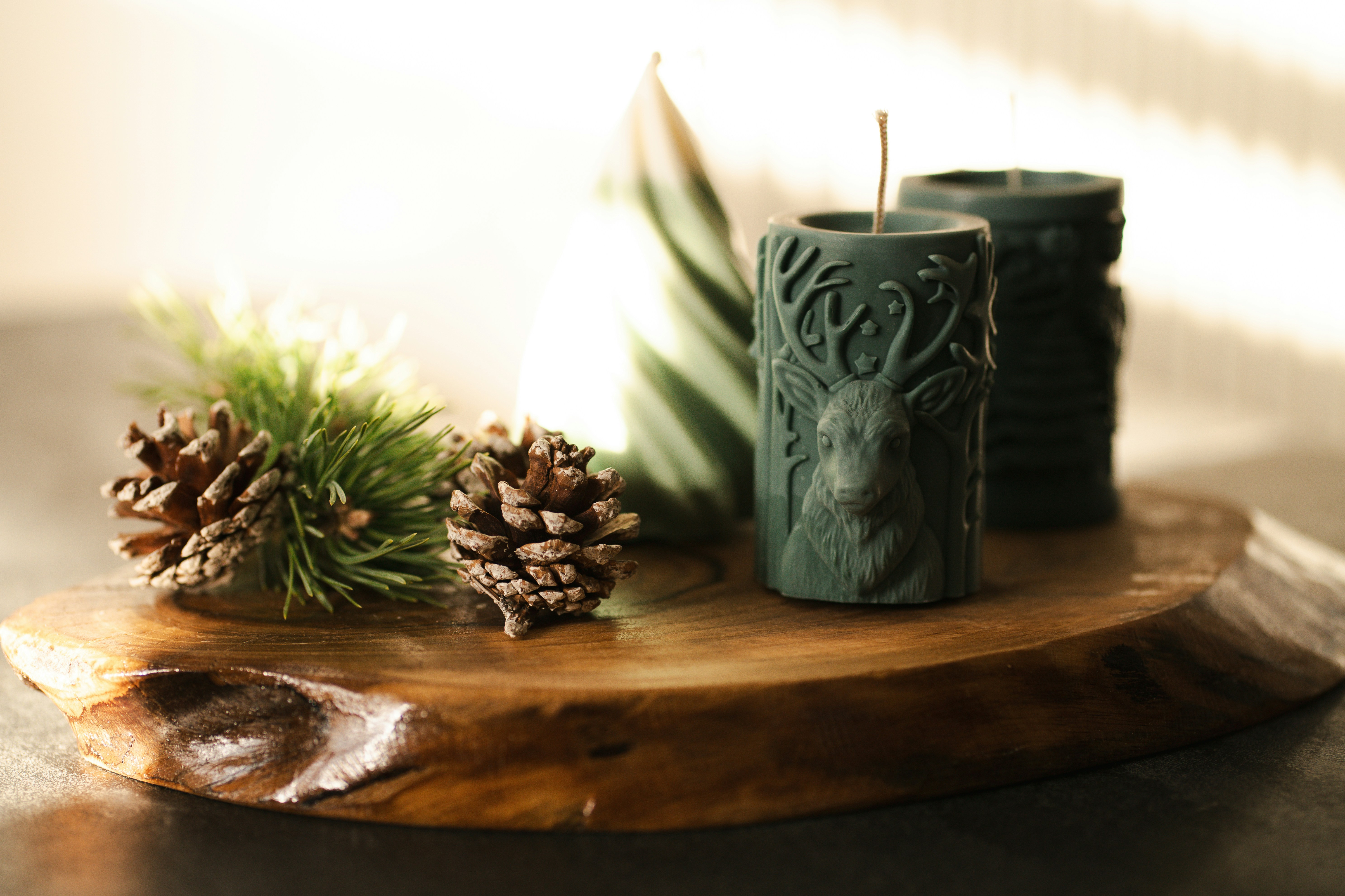 A couple of candles sitting on top of a wooden table