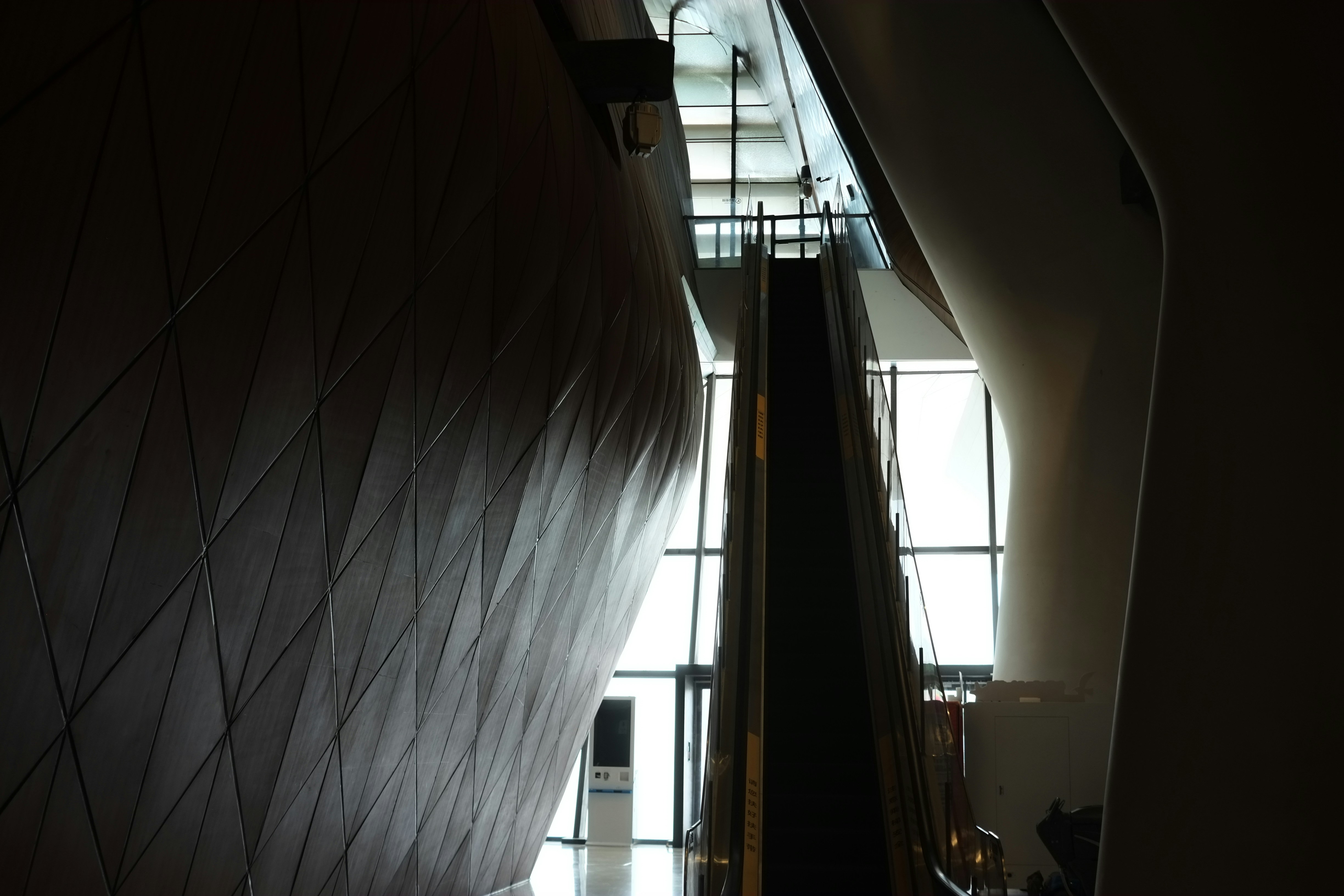 A long hallway with a light coming through the window