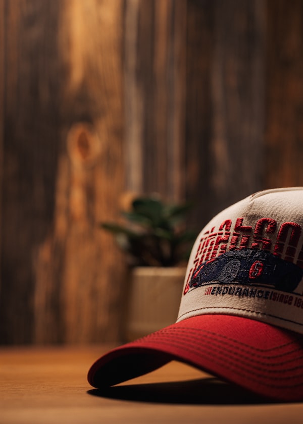 Red and white embroidered cap on a table