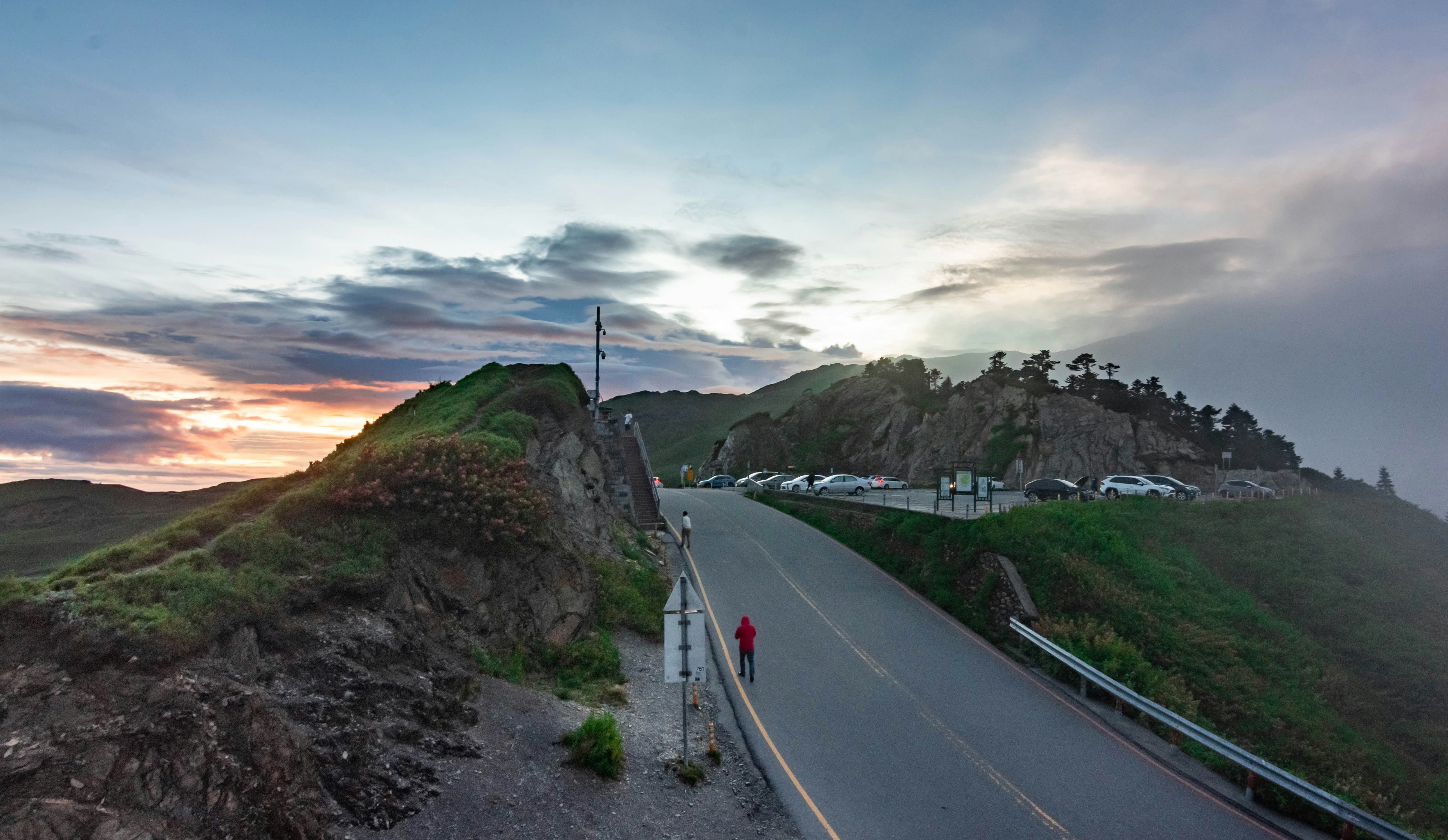 A long road with a hill in the background