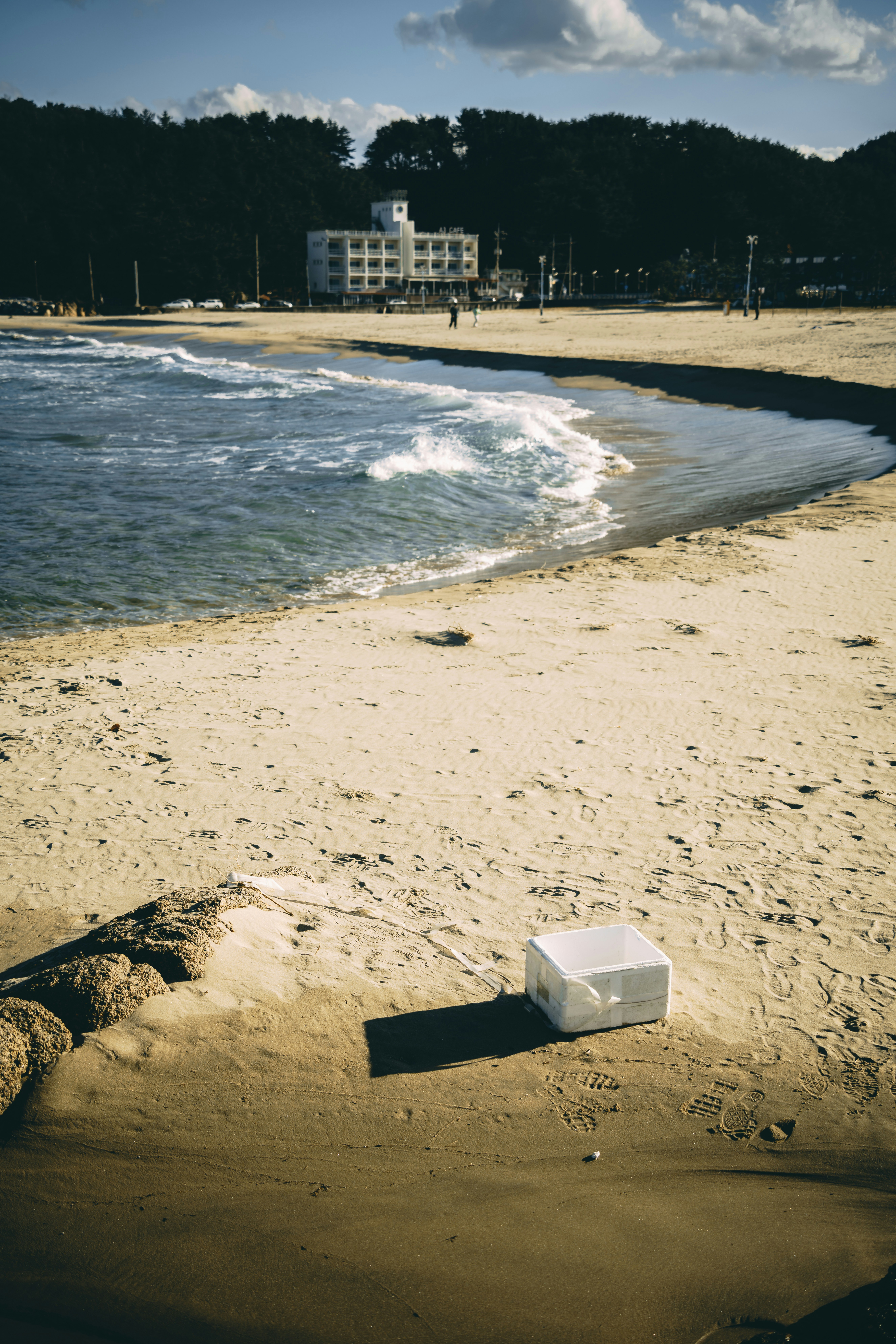 A white object sitting on top of a sandy beach