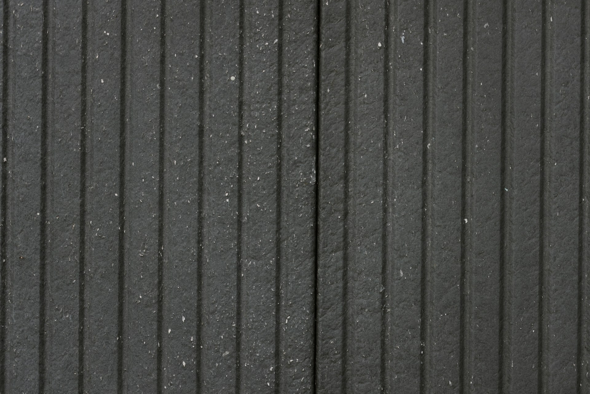 A man walking down a street next to a tall building