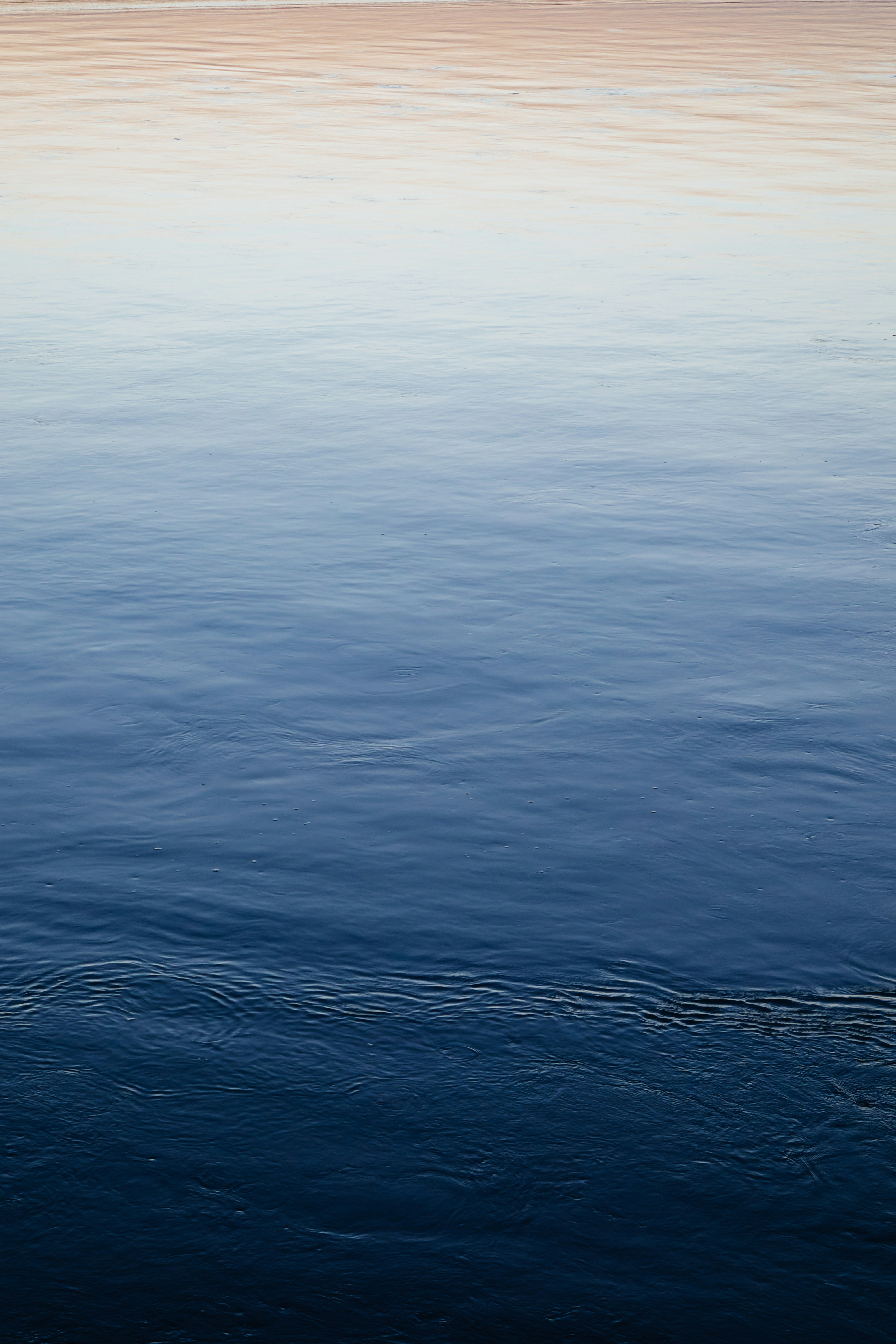 A large body of water with a boat in the distance