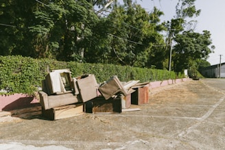 A bunch of broken furniture sitting on the side of a road