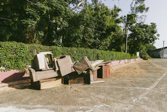 A bunch of broken furniture sitting on the side of a road