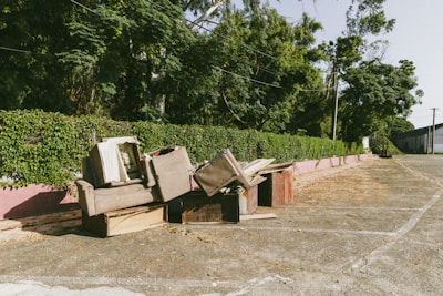 A bunch of broken furniture sitting on the side of a road