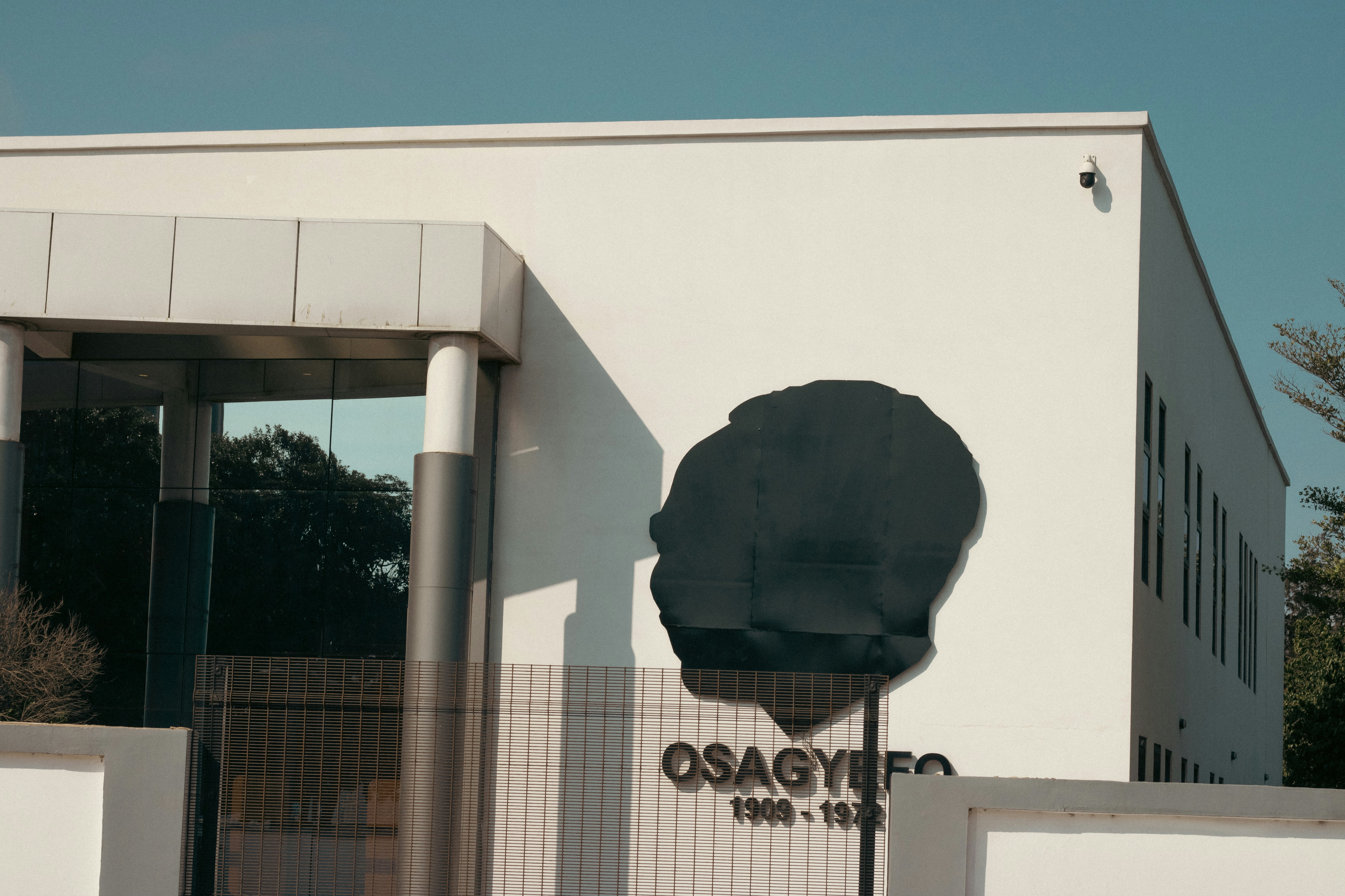 A white building with a black sign on it