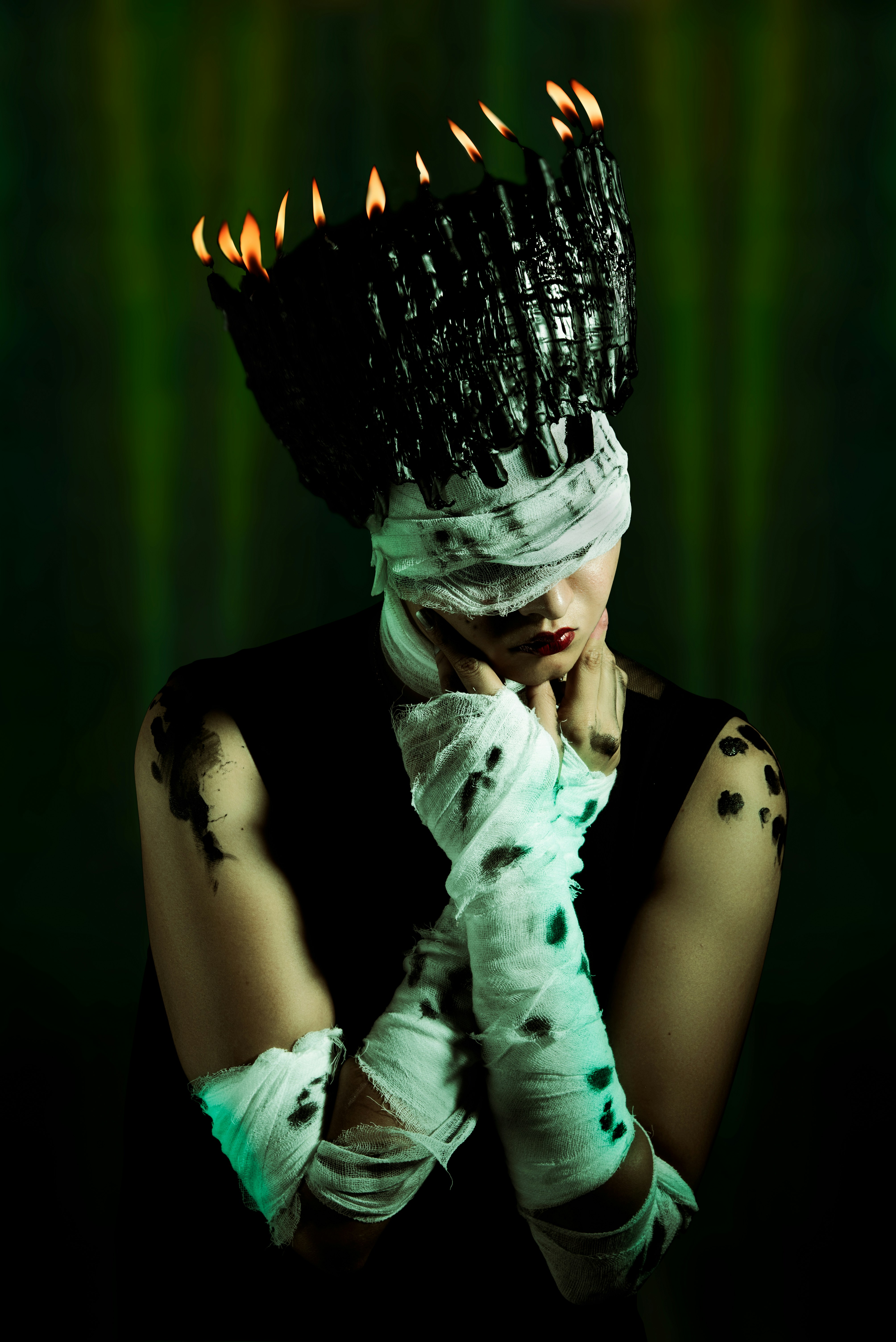 A woman in a black dress with a black and white crown on her head