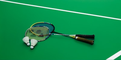 A tennis racket laying on a tennis court