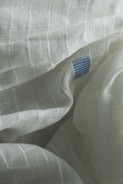 A close up of a white sheet with a blue dot on it