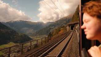 A woman looking out the window of a train