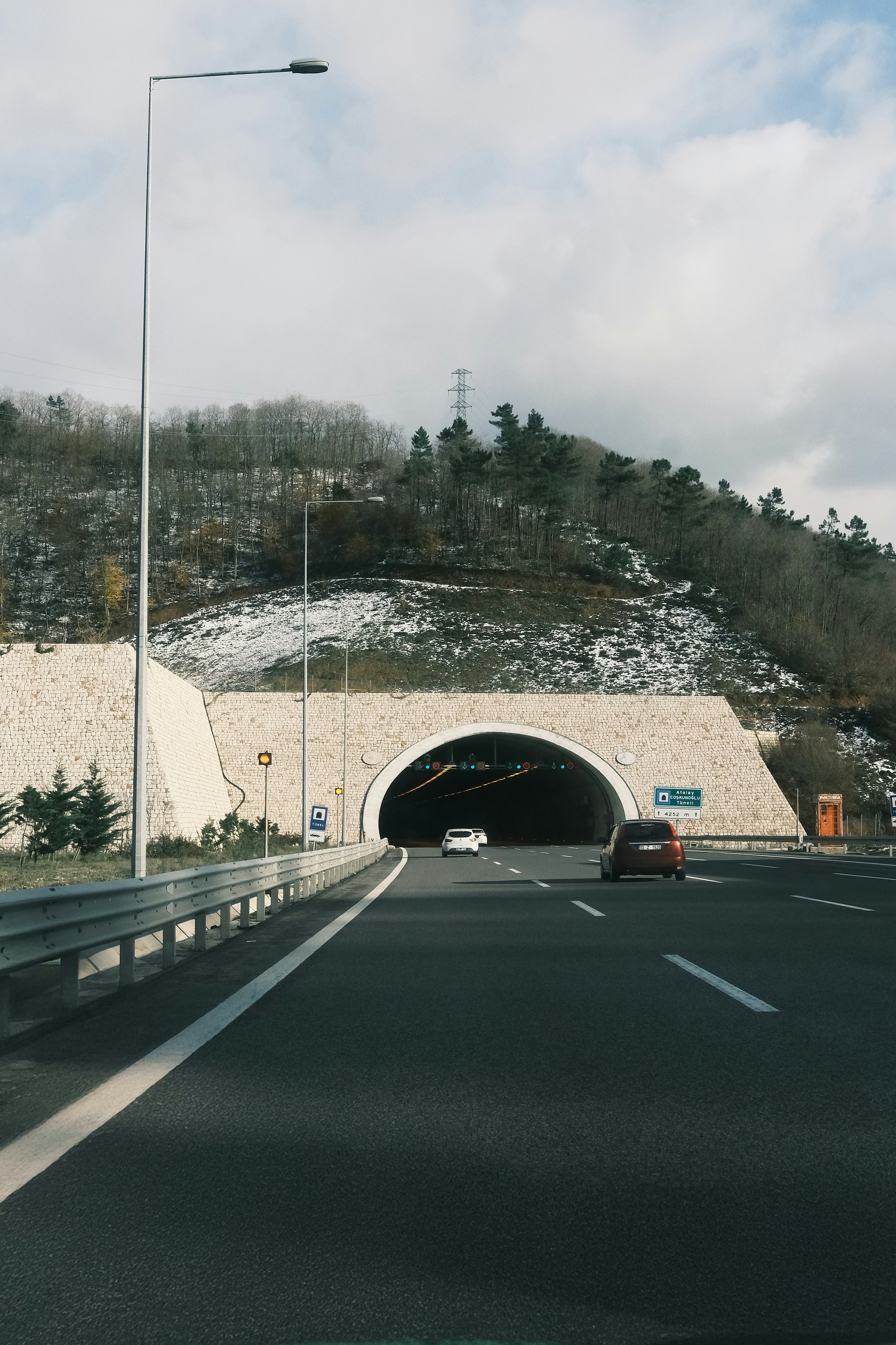 A car driving through a tunnel on a highway