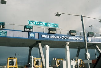 A bridge that has a bunch of signs on it