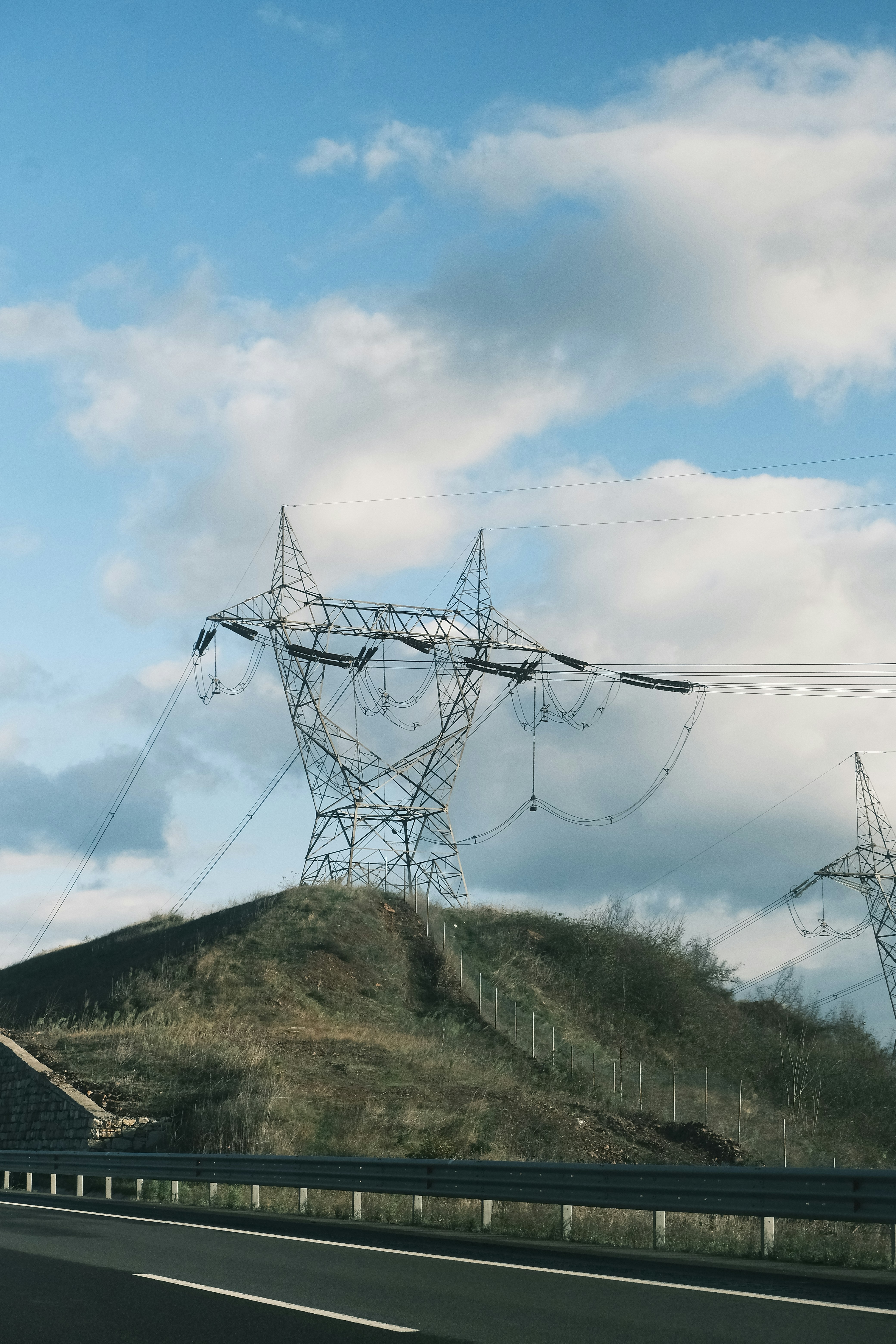 A car driving down a highway next to power lines