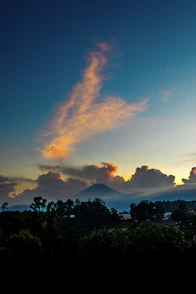 A beautiful sunset with clouds and mountains in the background