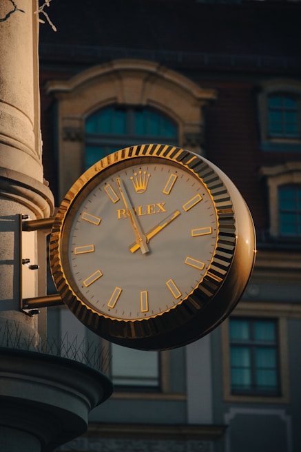 A clock on a pole in front of a building