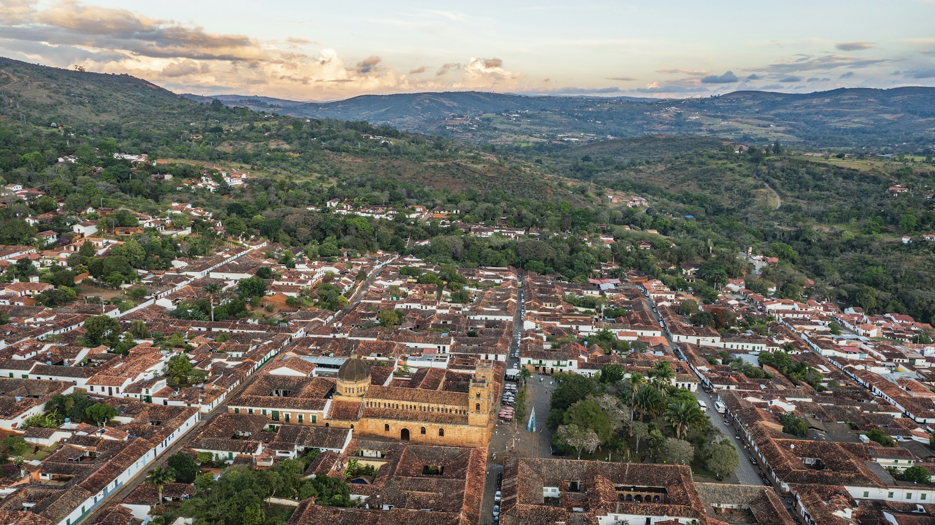 An aerial view of a city with mountains in the background