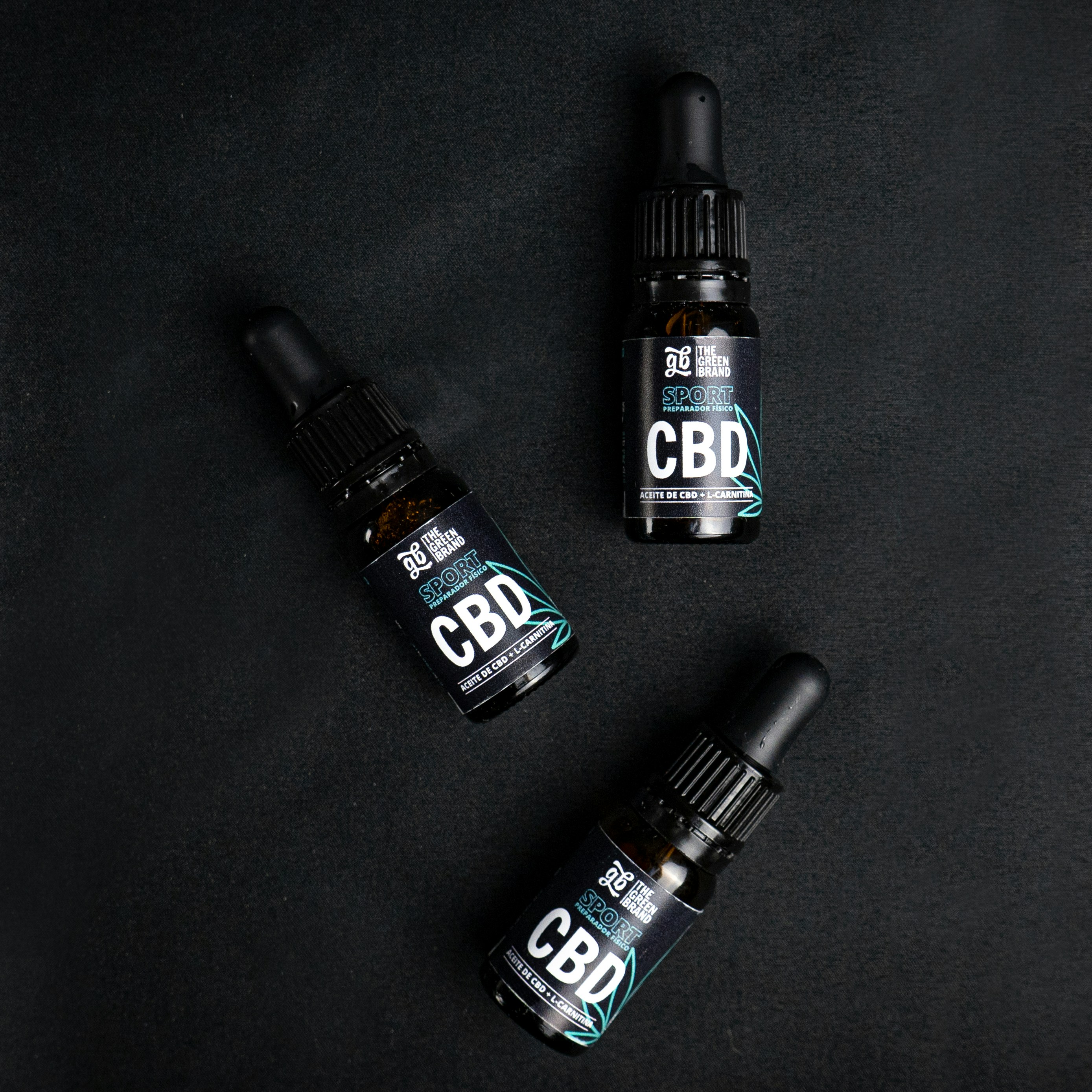 Three bottles of cbd sitting next to each other