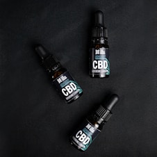 Three bottles of cbd sitting next to each other