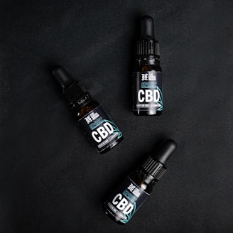 Three bottles of cbd sitting next to each other