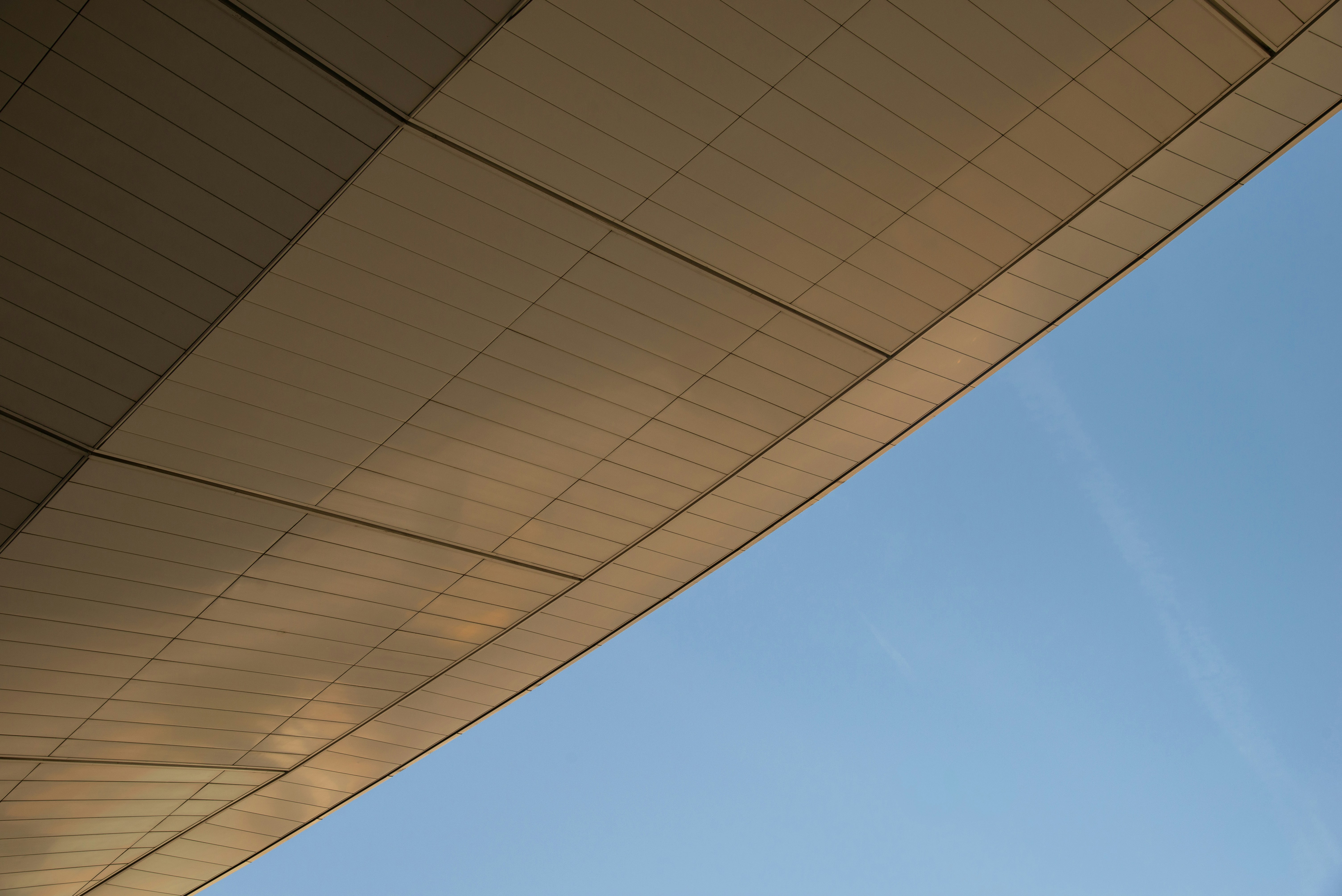 An airplane flying over the top of a building