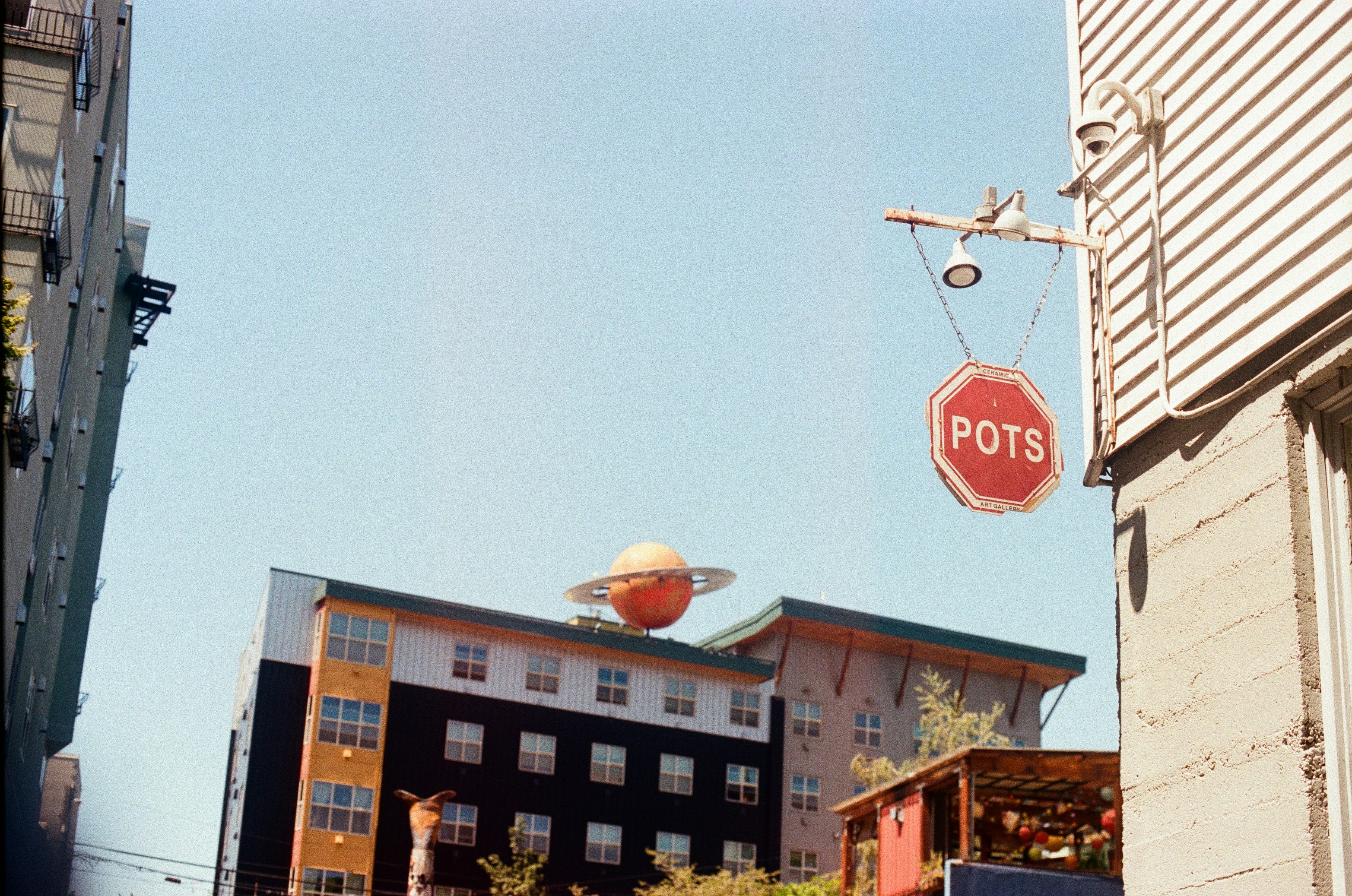 A red stop sign hanging from the side of a building