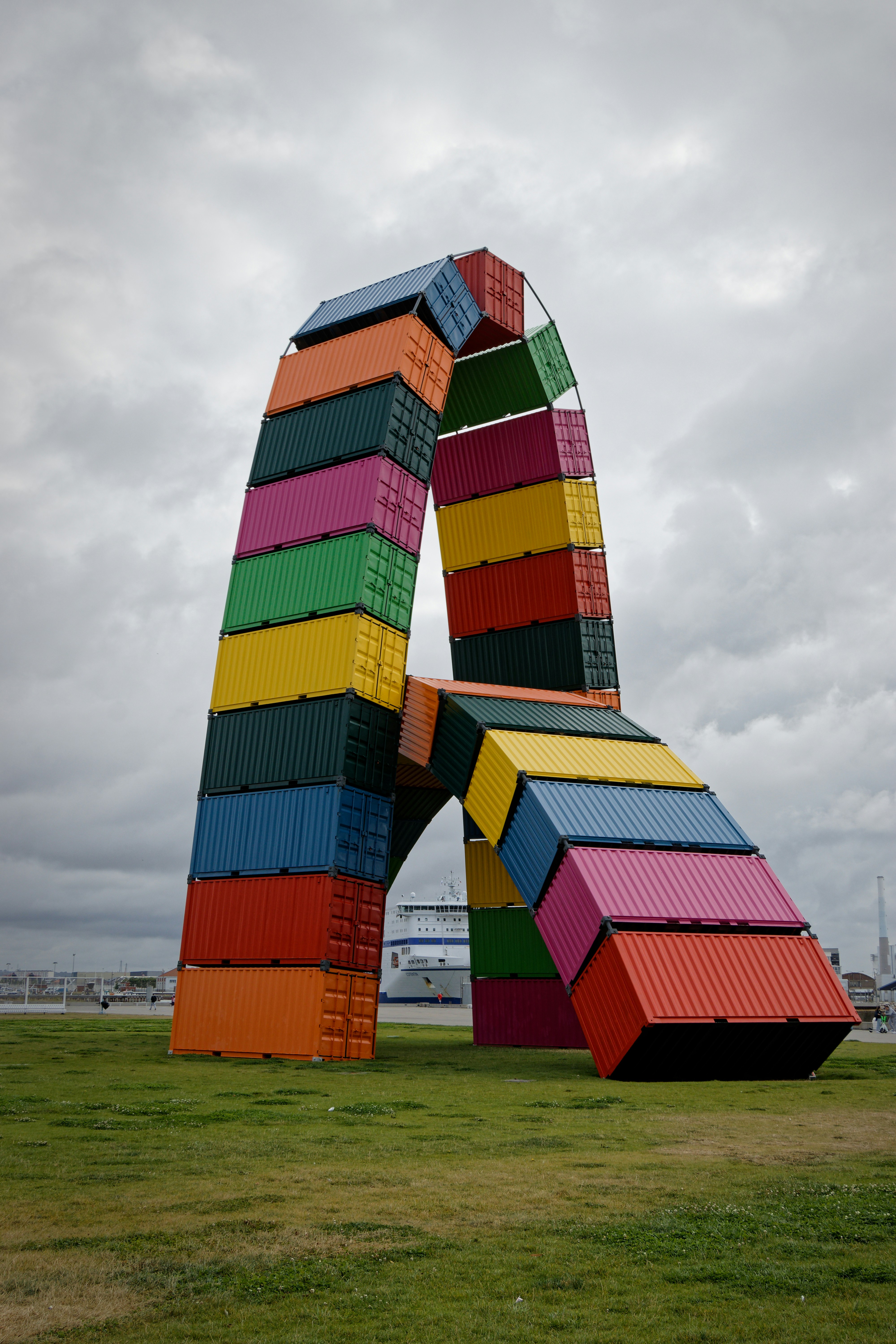A large multicolored sculpture in the middle of a field